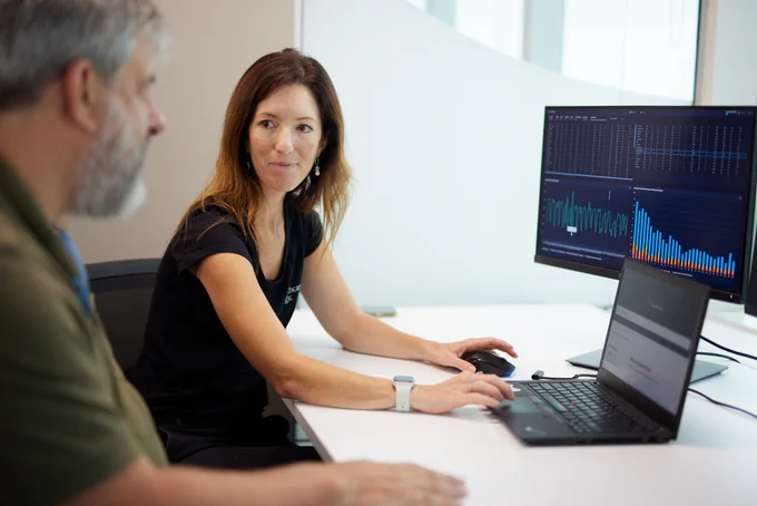 A woman and man on the computer