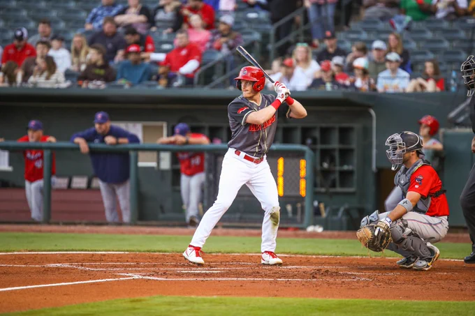 Conner Capel stands in the batters' box awaiting a pitch. Capel is playing for the Memphis Redbirds wearing the Wet Ribs theme jersey. 