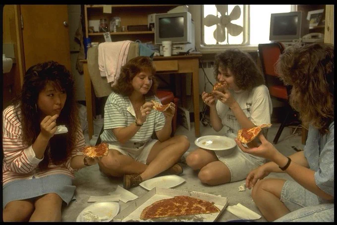 Students enjoy pizza in dorm room