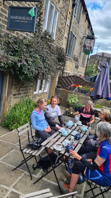 Mountain bikers in garden of coffee shop