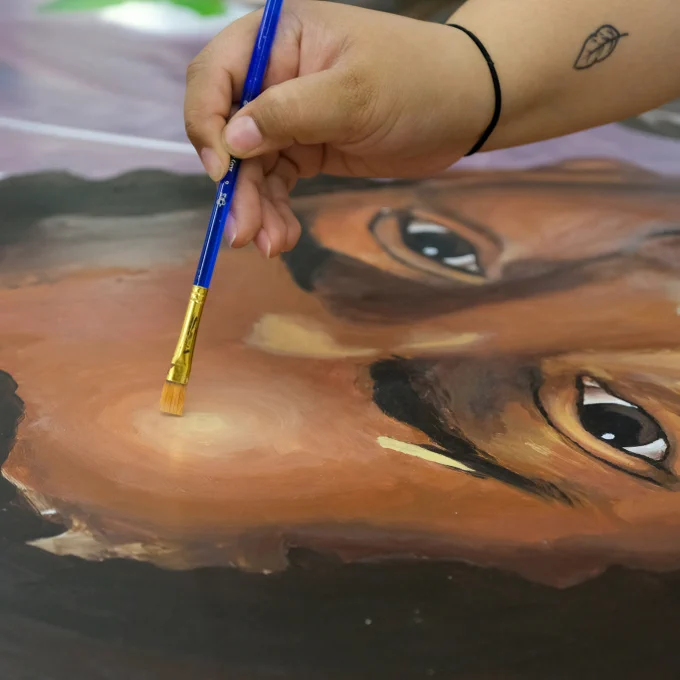 MIAD intern painting Africa mural