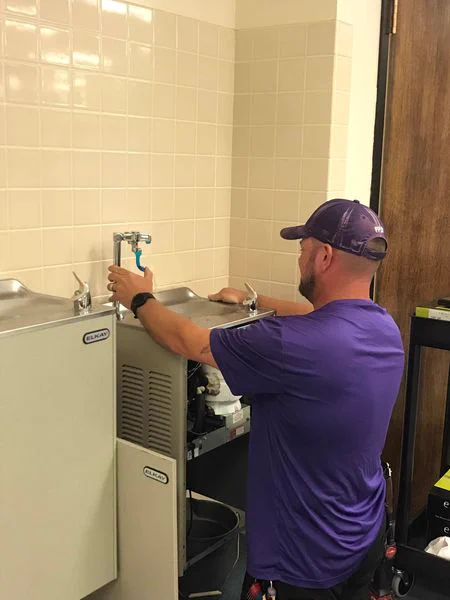plumber installing water refilling station