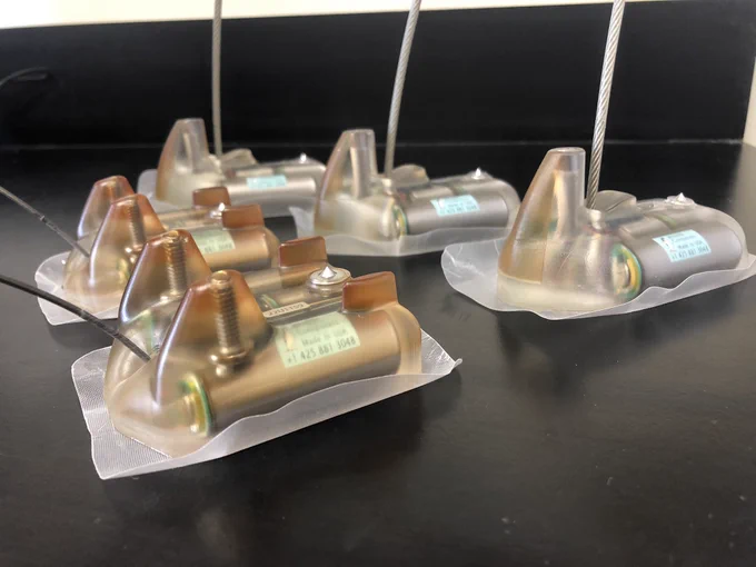 Five satellite transmitters of two different designs: side view.