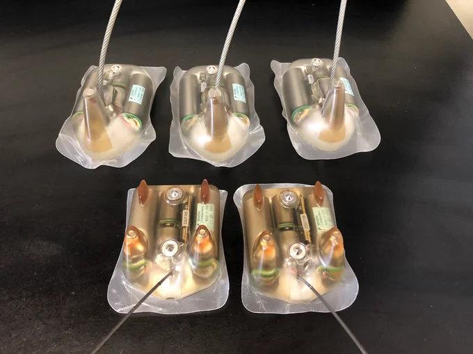 Five satellite transmitters of two different designs: top view.