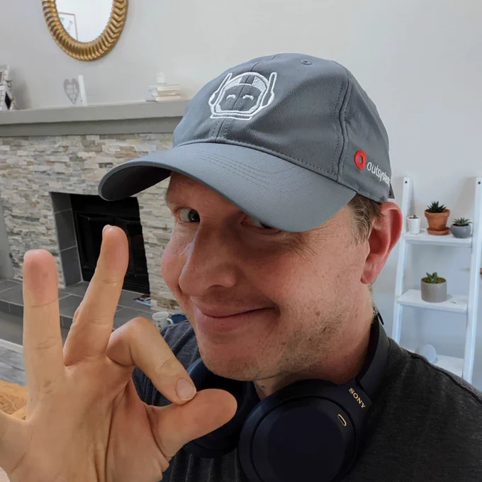 man wearing OutSystems baseball cap