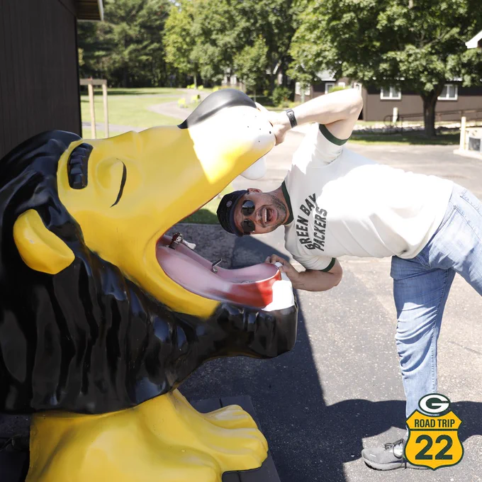 Jason Spitz places his head inside a lion drinking fountain (bubbler).