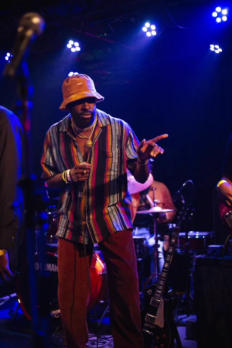 Obi on stage, pointing to his left.