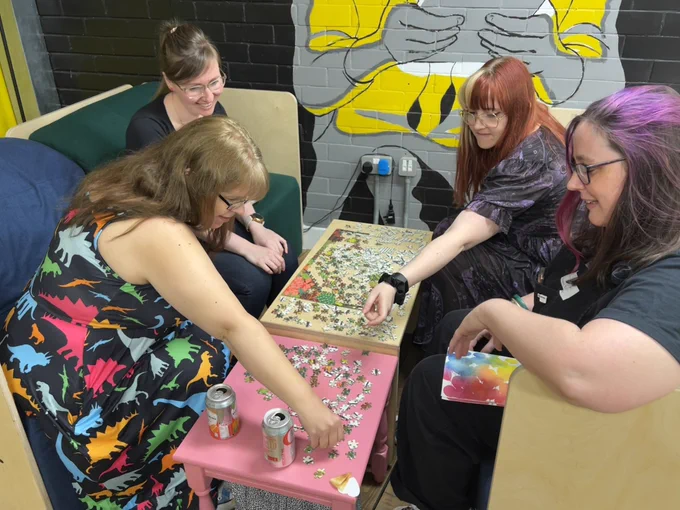 four of our lovely attendees assembling a plat filled conservatory jigsaw.