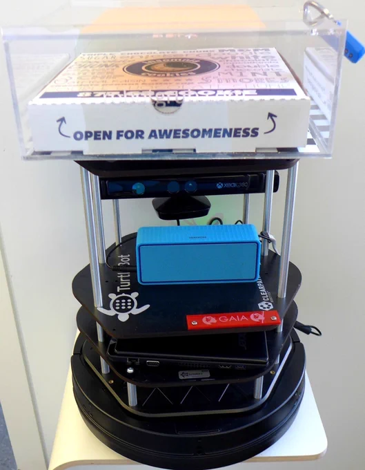 A small floor-based TurtleBot robot, disguised as a cookie delivery robot. 