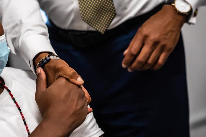 A close up on Mayor Adams hand as he shakes hands with a person in custody