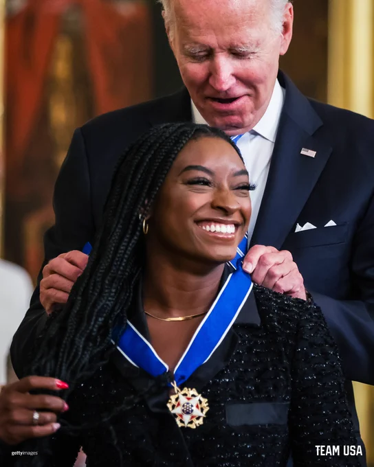 Simone Biles pictured receiving her medal of Freedom 