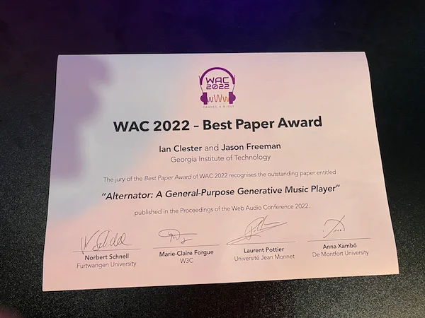 Picture of the "WAC 2022 - Best Paper Award" attributed to  Ian Clester and Jason Freeman (Georgia Institute of Technology) for "Alternator: A General-Purpose Generative Music Player" 