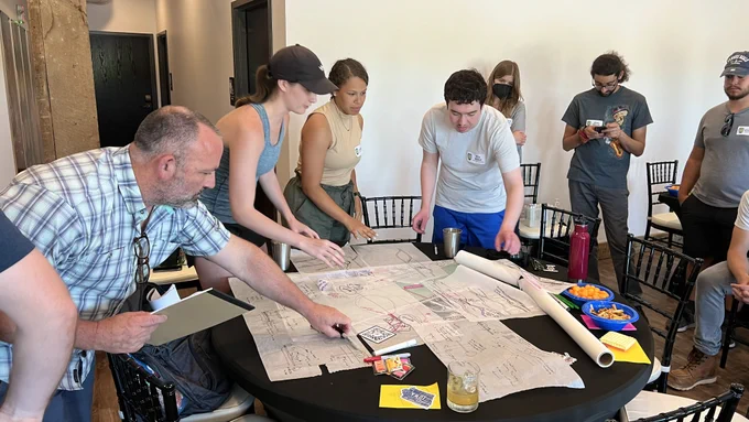 College students sketching ideas for a bison bridge
