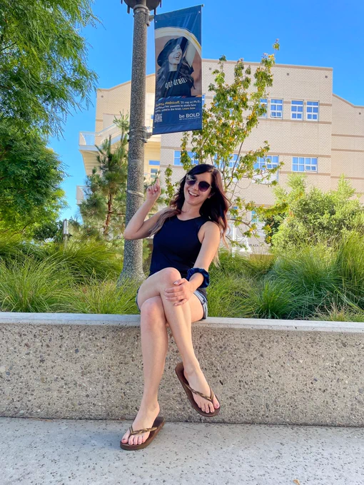 Photo of Solena in front of a banner of her at UCI