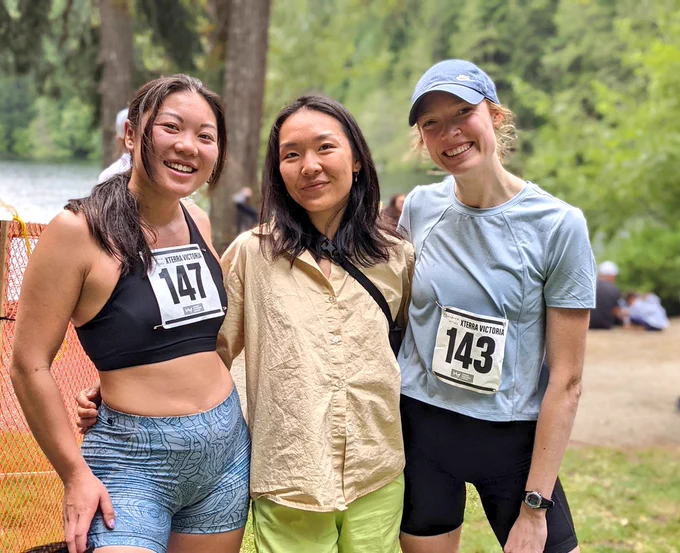 Racers and their friend celebrate at the finish line. 