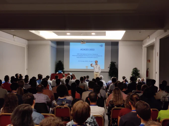 Koen De Bosschere introducing ACACES 2022 to a full room of participants