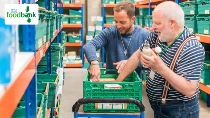 Image of Stroud District Foodbank volunteers packing a foodbox in their warehouse