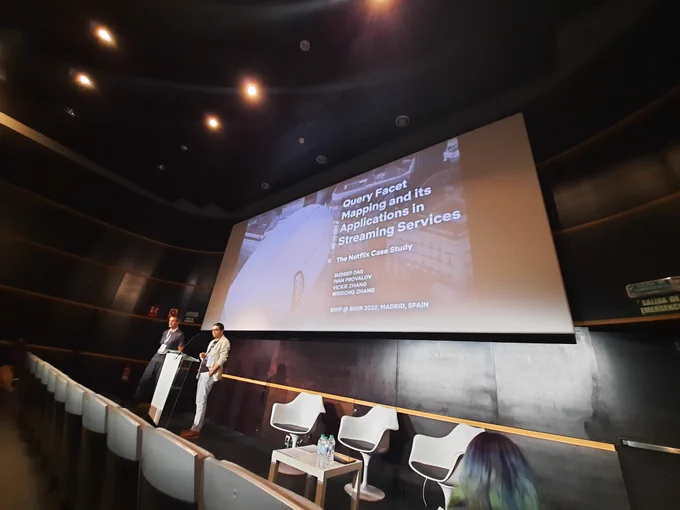 The two speakers with title slide saying "Query Facet Mapping and its application in streaming services"