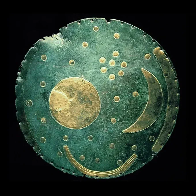 The Nebra Sky Disk: a copper plate with a golden design depicting the sun, moon, and stars