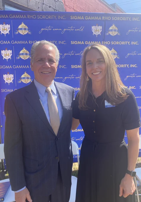 President James Danko and Dean of College of Education Brooke Kandel-Cisco pose together in front of a Sigma Gamma Rho backdrop.