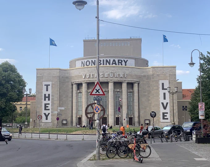 A theatre with a big banner across its front that reads ‘Non Binary’