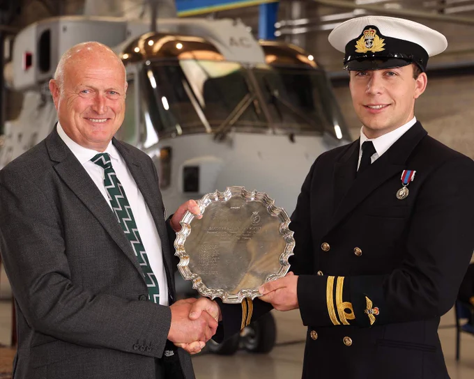 Mr Oz Smith presenting The Westland Trophy to Lt Patrick Richardson.