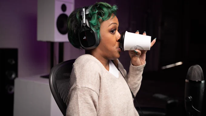 PleasantlyTwstd sipping from a coffee cup and looking to the right with an expression that says "not my business"