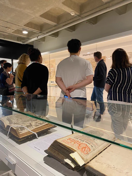 People looking at the exhibition about maps in bibles
