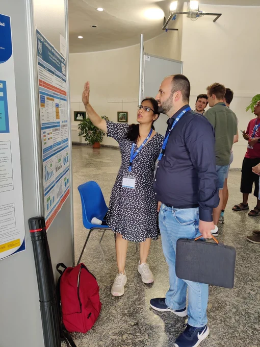 Student Sonia Rani Gupta discussing her poster with Francesco Conti at ACACES 2022