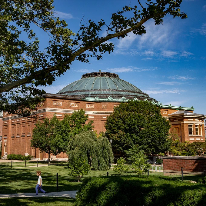Foellinger Auditorium with an emoji person walking in front of it