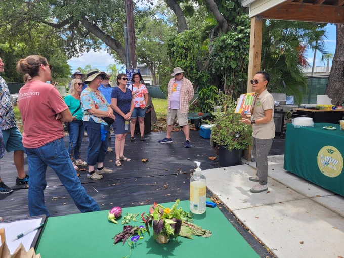 Thi Squire. Program manager welcomes everyone to fresh made lunch from local garden.