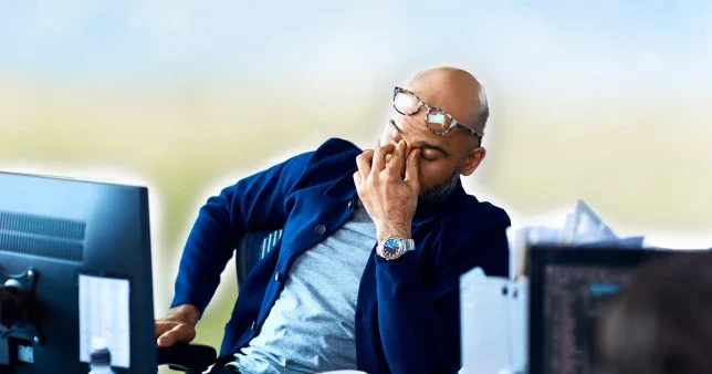 man looking stressed at work in front of a computer (Picture: Getty/Metro.co.uk)