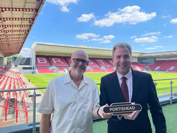 North Somerset Council Leader Cllr Steve Bridger and Metro Mayor Dan Norris holding a railway sign for Portishead at Ashton Gate Stadium