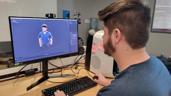 A student working with a 3D model in Blender 