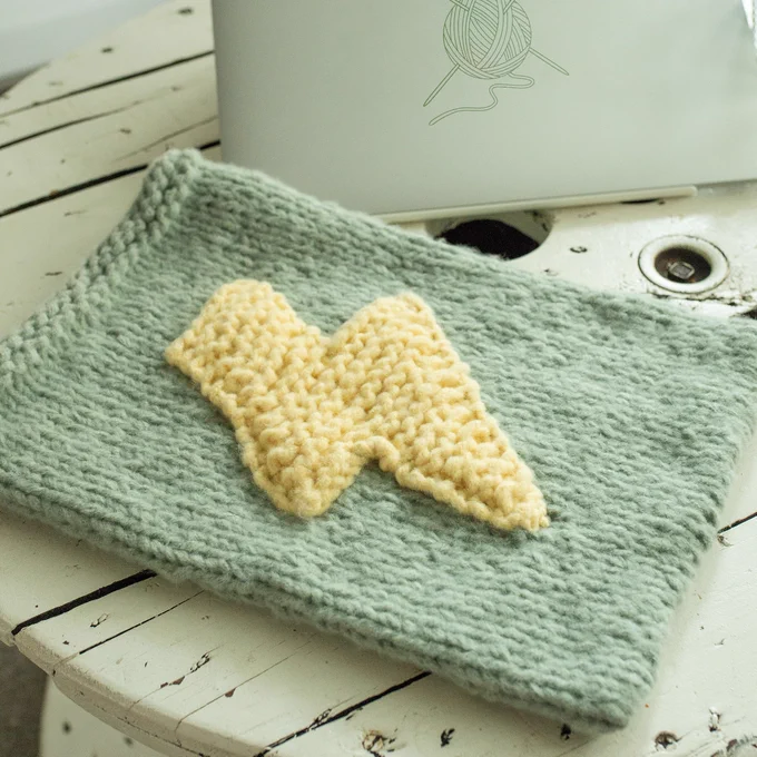 knitted laptop sleeve with firebolt design in front