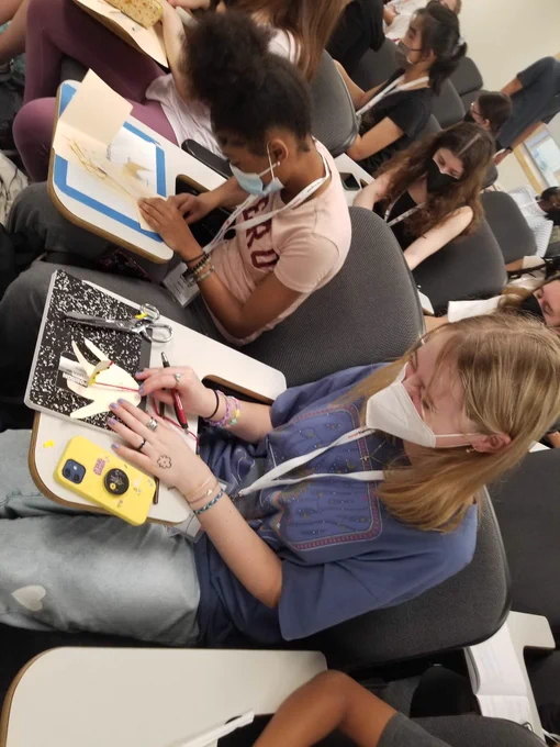 CURIE participants making biomechanical models of the hand consisting of bones (straws) and tendons (string).