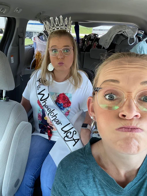 Sara and Angelina make fish faces at the camera inside her van.