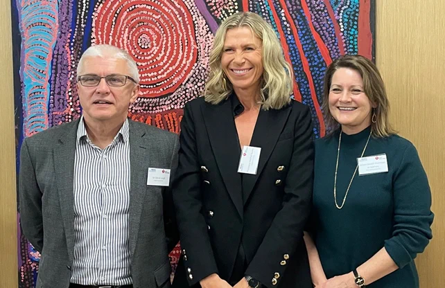Group image of Mr David Lloyd, Heart Foundation CEO, with Profs Rachel Huxley and Jo Salmon from Deakin University smiling in front of the camera.