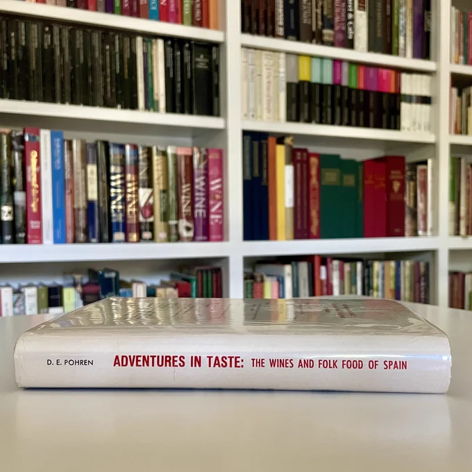 Book of Spanish wines and food lying on a desk in a library.