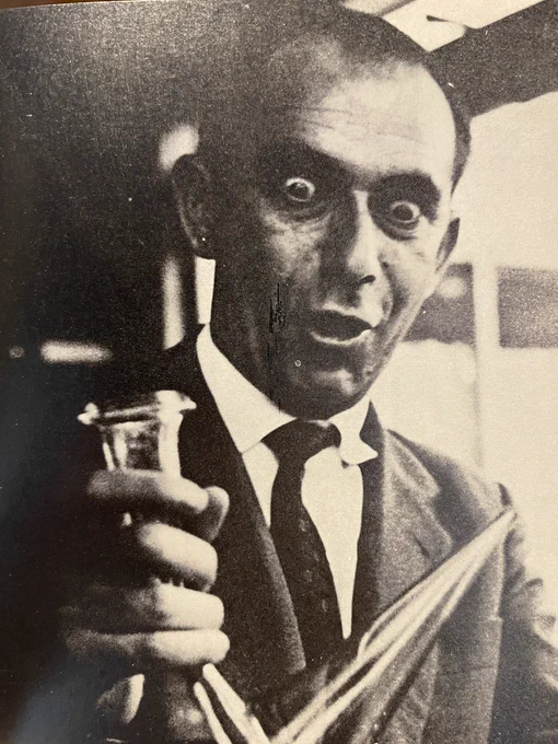 Catalán aficionado serenely contemplates a glass porrón full of his favorite wine.