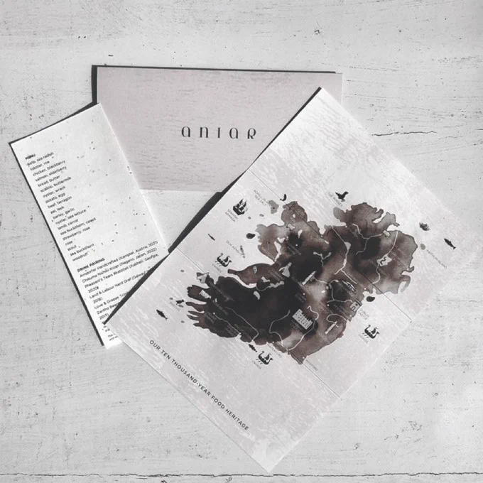 Aniar restaurant’s new menu, featuring a dark map of Ireland created with ink. It comes in an envelope.