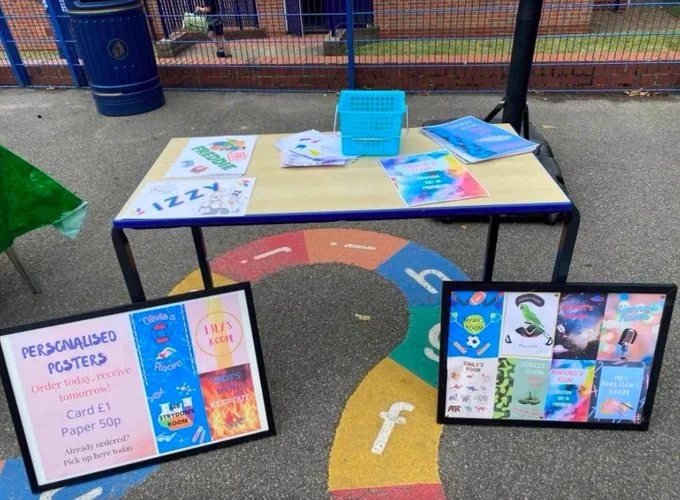 Table in school playground with arts and crafts on top.
