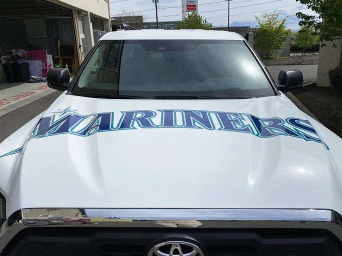 Seattle Mariners truck wrap, completed by SuperGraphics. Features Mariners icon on sides, “Sea us Rise” on the back, and the Mariners logo on the hood.