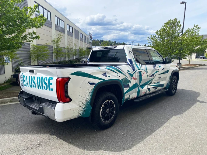 Seattle Mariners truck wrap, completed by SuperGraphics. Features Mariners icon on sides, “Sea us Rise” on the back, and the Mariners logo on the hood.
