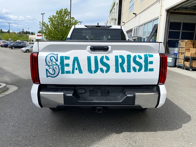 Seattle Mariners truck wrap, completed by SuperGraphics. Features Mariners icon on sides, “Sea us Rise” on the back, and the Mariners logo on the hood.