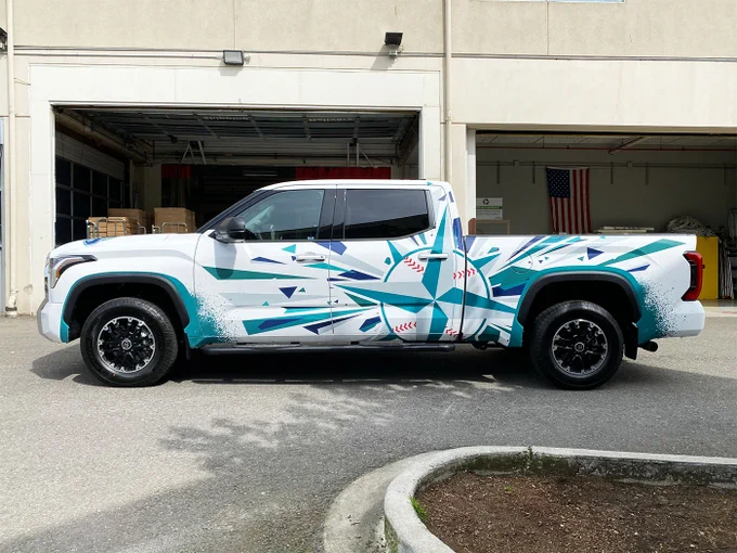 Seattle Mariners truck wrap, completed by SuperGraphics. Features Mariners icon on sides, “Sea us Rise” on the back, and the Mariners logo on the hood.