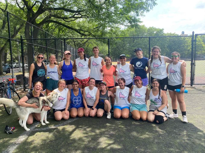 group photo of Dino players arter practice. many are wearing Dino pride tanks, all look very cool.