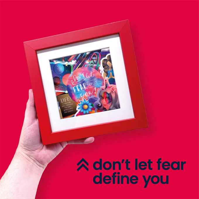 A Framed collage of colourful stickers, the focal point being a typography sticker with the quote “don’t let fear define you” the surrounding stickers include flowers, space, planets, a holographic unicorn headband and rainbow ribbons.