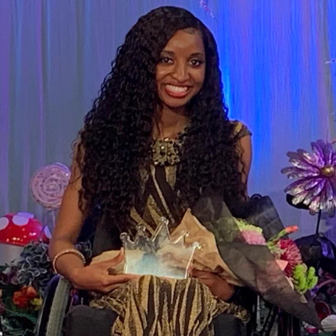 Bianca Faith Johnson, Ms. Wheelchair New York USA, on stage with her 2nd RU trophy and flowers