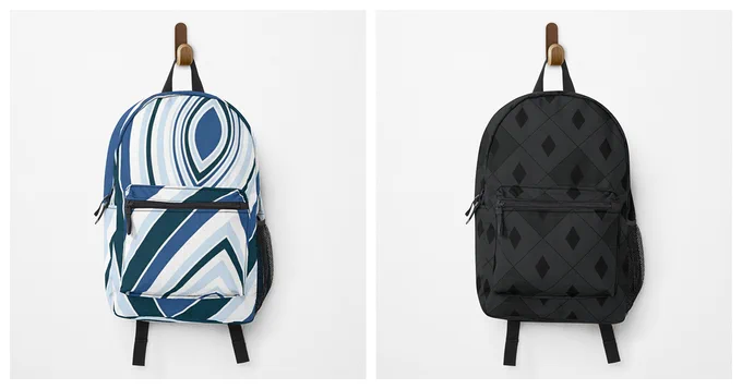Two packs backpacks hanging on a peg. Backpack on the left features a concave pattern radiating out in different shades of blue. Backpack on the right features a dark diamond harlequin pattern coloured in black and dark grey.
